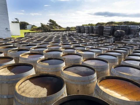 Whiskey barrels at the Ardbeg distillery in Ardbeg near Port Ellen on Islay, Inner Hebrides, Scotland, UK. xkwx Scotland coast island Hebrides Inner Hebrides Islay Isle of Islay Port Ellen whiskey distillery drink alcohol manufacturing building white Ardbeg barrel water