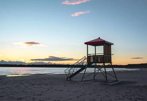 view of a lifeguard deck on the shore of the sea at sunset time xkwx beach beautiful blue clouds coast coastline dusk evening horizon landscape lifeguard light nature ocean orange outdoor red sand scenic sea sky summer sun sunrise sunset tourism tower travel vacation water finland yyterri pori satakunta no people