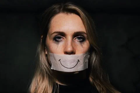 abuse and domestic violence. sad depressed woman hide her mouth behind fake drawn smile on paper tape. depression and mental health xkwx woman violence abuse depression mental health relationship domestic istanbul convention fake smile victim violent aggression censored adhesive family paper tape helpless mouth cover silenced afraid shut despair pain physical crying scared hurt fear problem assault female dark black
