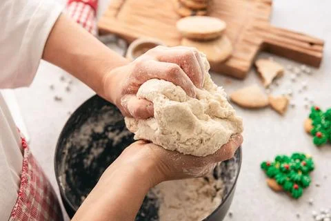 Hands knead thick dough on the kitchen table, decorated with festive decorations for Christmas and New year, baking at home. xkwx christmas food pastry dough homemade flour hand cooking gingerbread baking traditional kitchen table woman holiday xmas cookie sweet sugar bake cook home cake dessert biscuit delicious bowl celebration domestic person kneading lifestyle handmade fresh tasty recipe natural organic nutrition baked ingredient bakery chef dish preparation culinary festive