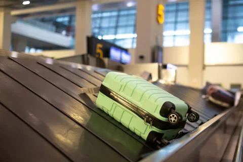 The luggage belt with suitcases being delivered to the passengers at the arrival terminal xkwx adventure air travel airport arrival background bag baggage belt blur blurred building business carousel cart city claim design domestic equipment holidays industrial industry interior international luggage modern problem protest public service staff strike terminal tourism transfer transit transport transportation trip trolley waiting work
