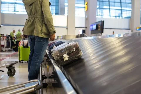 The luggage belt with suitcases being delivered to the passengers at the arrival terminal xkwx adventure air travel airport arrival background bag baggage belt blur blurred building business carousel cart city claim design domestic equipment holidays industrial industry interior international luggage modern problem protest public service staff strike terminal tourism transfer transit transport transportation trip trolley waiting work