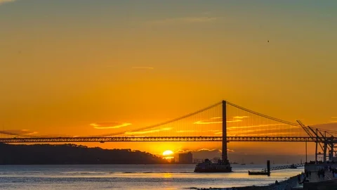 The 25th of April Bridge in the light of setting sun in Lisbon Stock Footage 90952324