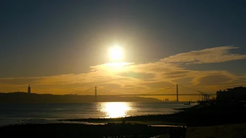 The 25th of April Bridge in the light of setting sun in Lisbon Stock Footage 90953156