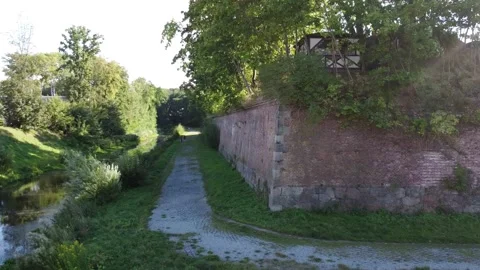 26 flying over the moat, old protective wall Stock Footage 266942796