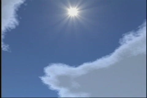 2602 Puffy white clouds sun behind Stock Footage 825967