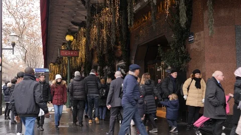 27 Rainy gray winter day Paris Lafayette Gallery frontage people crowd Stock Footage 100813746