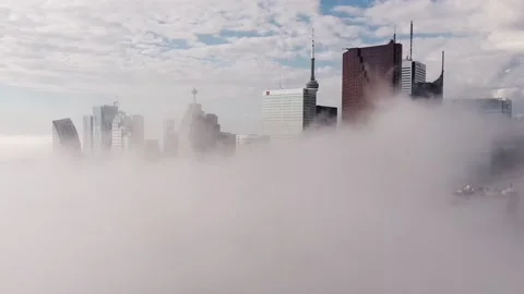 2.7K aerial flight through dense fog that sits on top of Toronto skyline Stock Footage 149896799