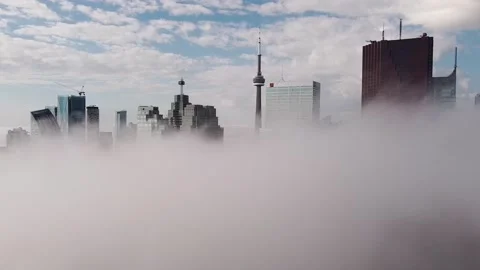 2.7K aerial flight through dense fog revealing Toronto skyline over fog Stock Footage 149896911