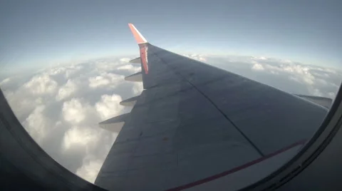 2.7K. Airplane wing out of window on blue sky background, Full HD. 2704x1524 Stock Footage 40503329
