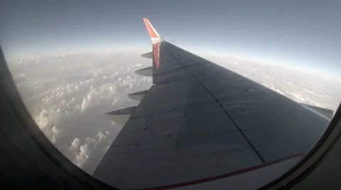 2.7K. Airplane wing out of window on blue sky background, Full HD. 2704x1524 Stock Footage 40503407