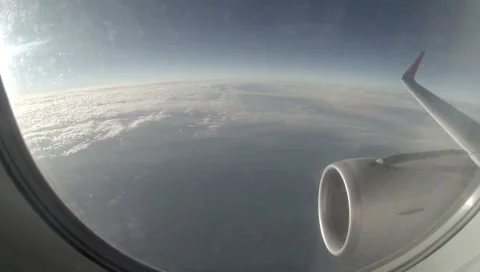 2.7K. Airplane wing out of window on blue sky background, Full HD. 2704x1524 Stock Footage 47808936