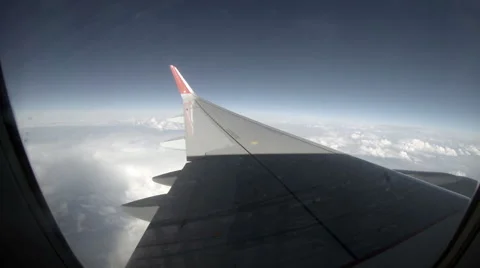 2.7K. Airplane wing out of window on blue sky background, Full HD. 2704x1524 Stock Footage 47809074