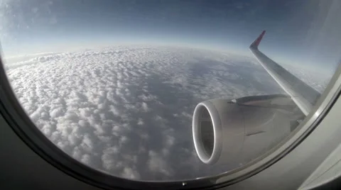 2.7K. Airplane wing out of window on blue sky background, Full HD. 2704x1524 Video stock 47809181