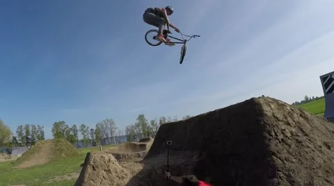 2.7k bmx rider does a set of nice tricks over big jumps Stock Footage 50365480