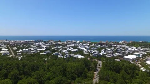2.7K Drone Backing Up From Ocean and Town Over Woods Stock-Footage 109229719
