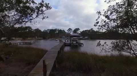 2.7K Drone Flying Out Over Dock Into Lake With a Boat Video stock 109230724