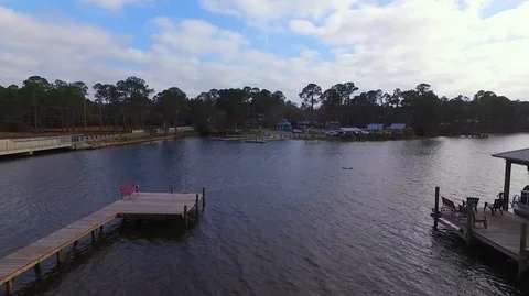 2.7K Drone Flying Over Dock With Dolphin Peaking Out of the Water Stock-Footage 109299642