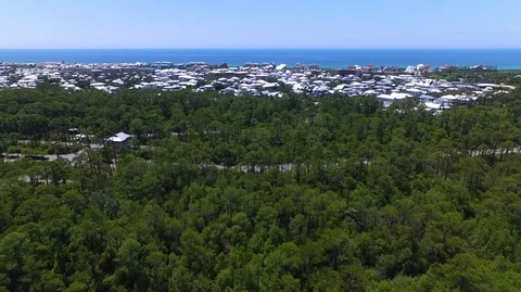2.7K Drone Flying Over Forest Towards Town and Ocean Stock-Footage 109230708