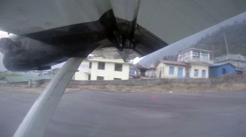 2.7K. Take off on the plane from Lukla, Nepal. Airplane wing out of window Stock Footage 40503207