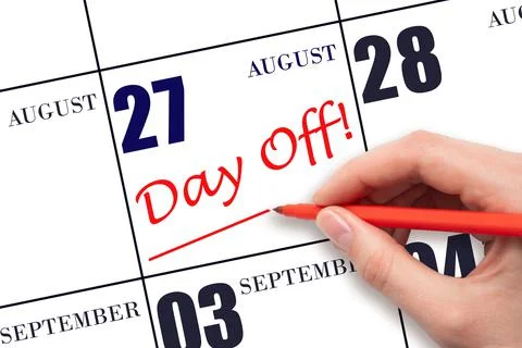 27th day of August. Hand writing text DAY OFF and drawing a line on calendar  Stock Photos