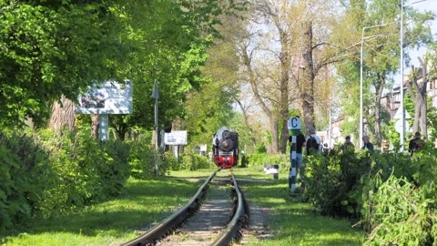 28 of April, 2024. Approaching Old Steam Children Train on Sunny Day in Park Stock Footage 274535358