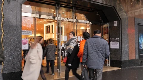 28 Rainy gray winter day Paris Lafayette Gallery entrance shopping people Stock Footage 100813699