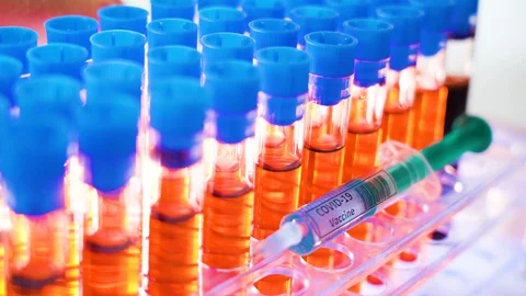 28527 The red fluids inside the test tubes and the small syringe for coronavi Stock Footage 128405925