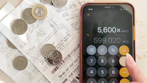 29 August 2025, Toronto, Canada — Receipts and coins on a table with calculator  Stock Footage 314870839