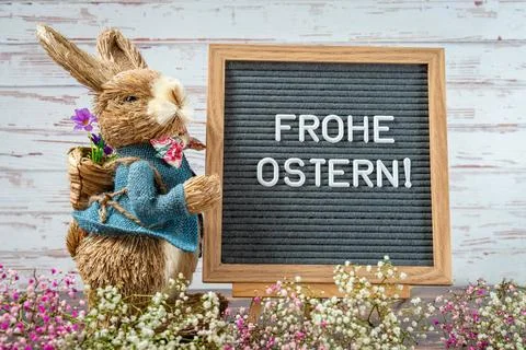 29 March 2023: Easter bunny with a text board with inscription: Happy East... Stock Photos