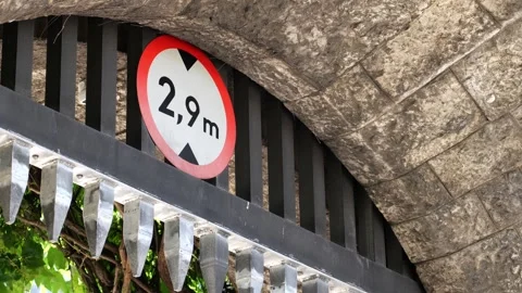 2.9 meter vehicle height restriction sign mounted inside a black metal gate.. Stock Footage 339372849