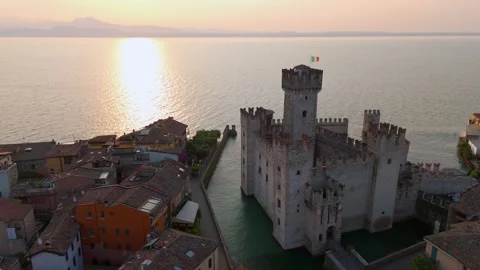Sun rising at Castello Scaligero di Sirmione, Lake Garda, Italy - Aerial Drone Sun rising at Castello Scaligero di Sirmione, Lake Garda, Italy - Aerial Drone