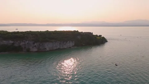 Flight over Peninsula at Sunset, Sirmione, Lake Garda, Italy - Aerial Drone Flight over Peninsula at Sunset, Sirmione, Lake Garda, Italy - Aerial Drone