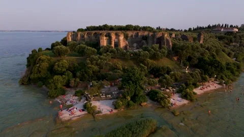 Pan back Sirmio Peninsula at Sunset, Sirmione, Lake Garda, Italy - Aerial Drone Pan back Sirmio Peninsula at Sunset, Sirmione, Lake Garda, Italy - Aerial Drone