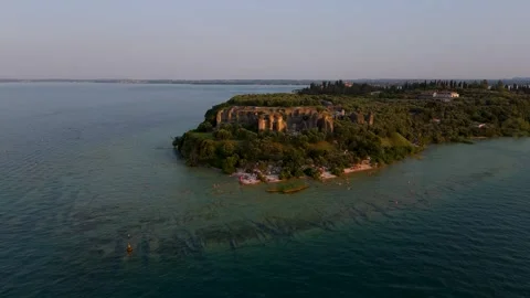 Small beach on Peninsula at Sunset, Sirmione, Lake Garda, Italy - Aerial Drone Small beach on Peninsula at Sunset, Sirmione, Lake Garda, Italy - Aerial Drone
