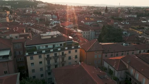 Glare from rising sun over Verona, Italy - Aerial Drone