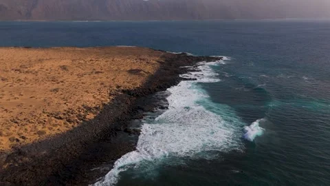 Black volcanic coastline of La Graciosa, Canary Islands, Spain - Aerial Drone Black volcanic coastline of La Graciosa, Canary Islands, Spain - Aerial Drone