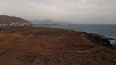 Approaching Playa Blanca from Punta Pechiguera, Lanzarote, Spain - Aerial Drone