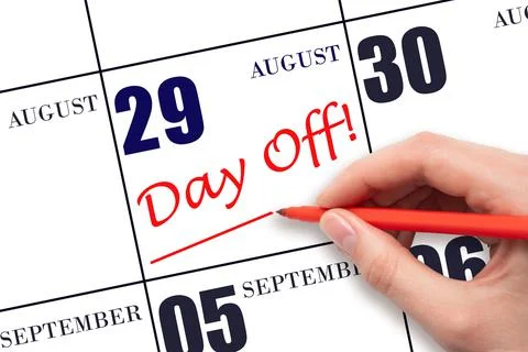 29th day of August. Hand writing text DAY OFF and drawing a line on calendar  Stock Photos