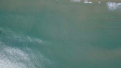 2K Aerial Drone Top Down view of green sea and white sand beach. Water surface Stock Footage 128029503
