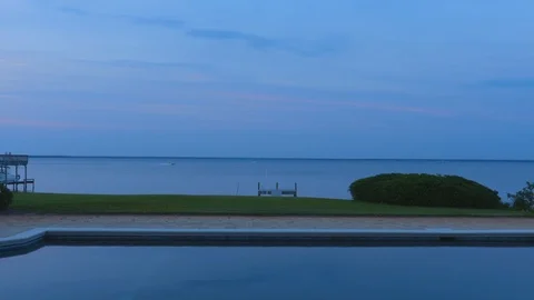 2K Looking Out Over Pool to Beautiful Water at Twilight Stock-Footage 111282403