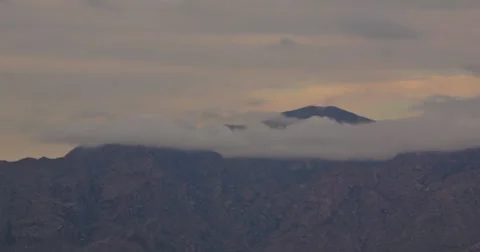 2K Video 30p Low hanging clouds swirl around mountain peak Stock Footage