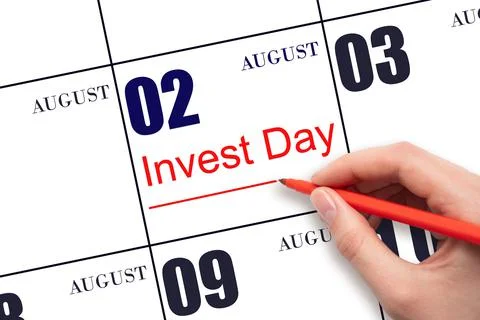2nd day of August. Hand drawing red line and writing the text Invest Day on c Stock Photos