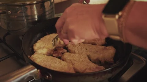 2x slowed Chef is turning around crunchy escalops on the frying pan Stock Footage 309034484
