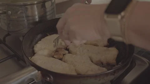 2x slowed SLog3 Chef is turning around crunchy escalops on the frying pan  Stock Footage 309034476