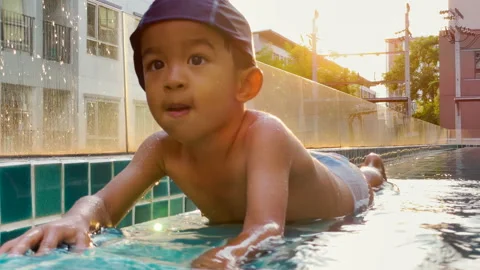 3-4 year preschool boy practice swim in swimming pool in condominium Stock Footage 166662611