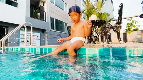 3-4 year preschool boy practice swim in swimming pool in condominium building Stock Footage 166662620