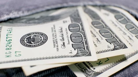 3 American Banknotes of 100 Dollars in a jeans pocket on rotating table. Stock Footage 142081850