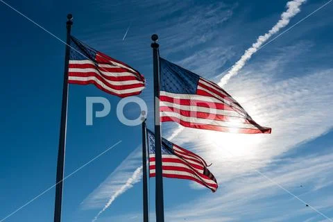 3 American Flags against a blue sky Stock Photos