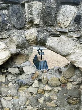 3 Benches Through a Stone Window. Stock Photos